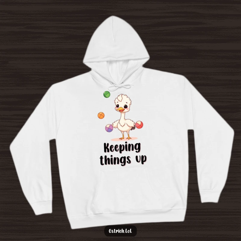 Funny cheerful ostrich juggling colorful balls on a hoodie, a cozy and humorous funny gift.